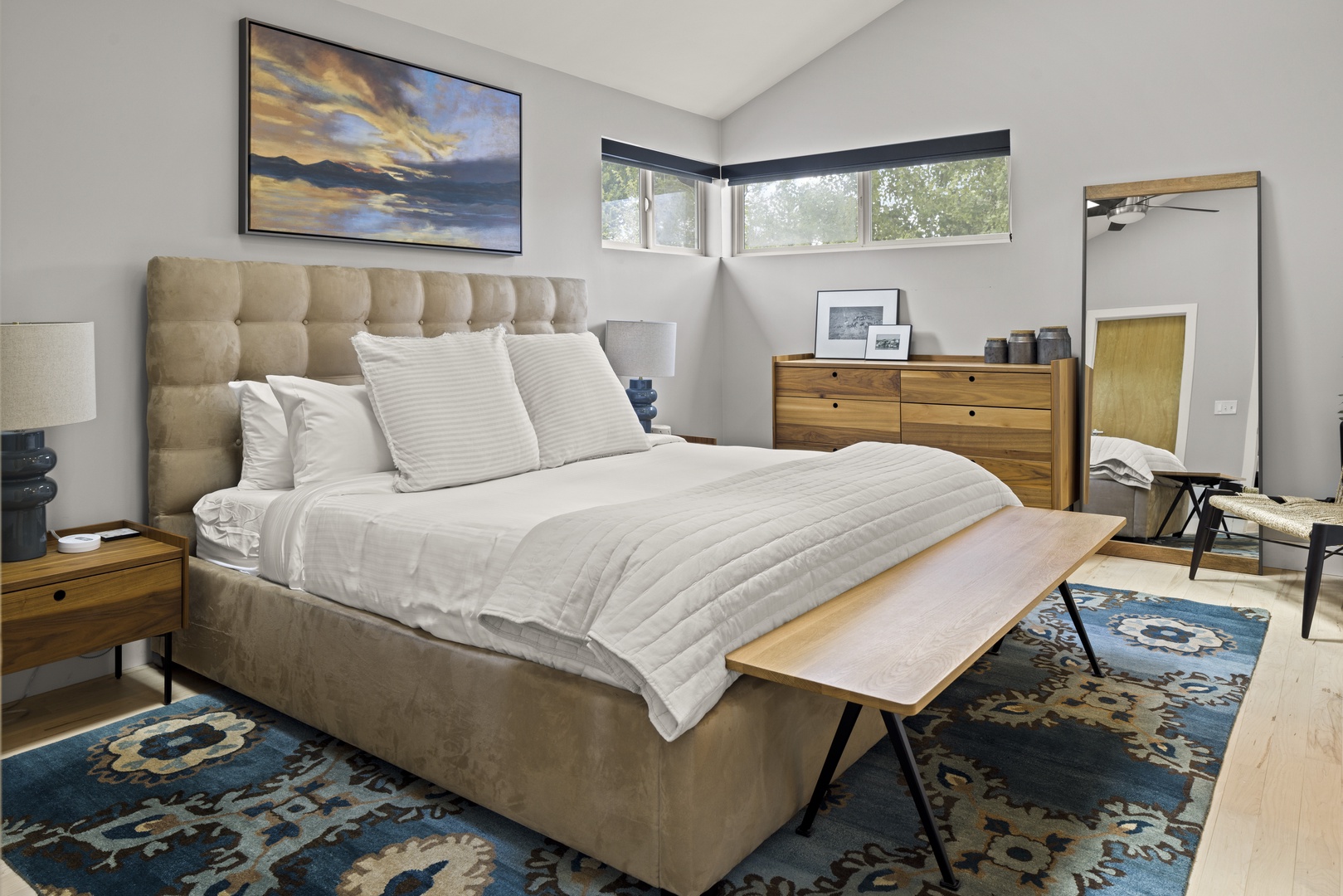 Sink into your plush tufted bed and let natural light fill this serene space designed for perfect rest.