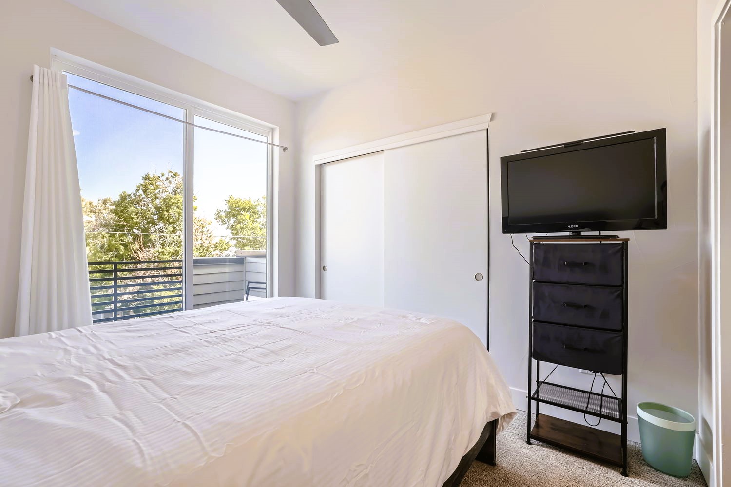 Wake up to leafy treetop views in your peaceful bedroom, complete with entertainment and storage for a perfect stay.