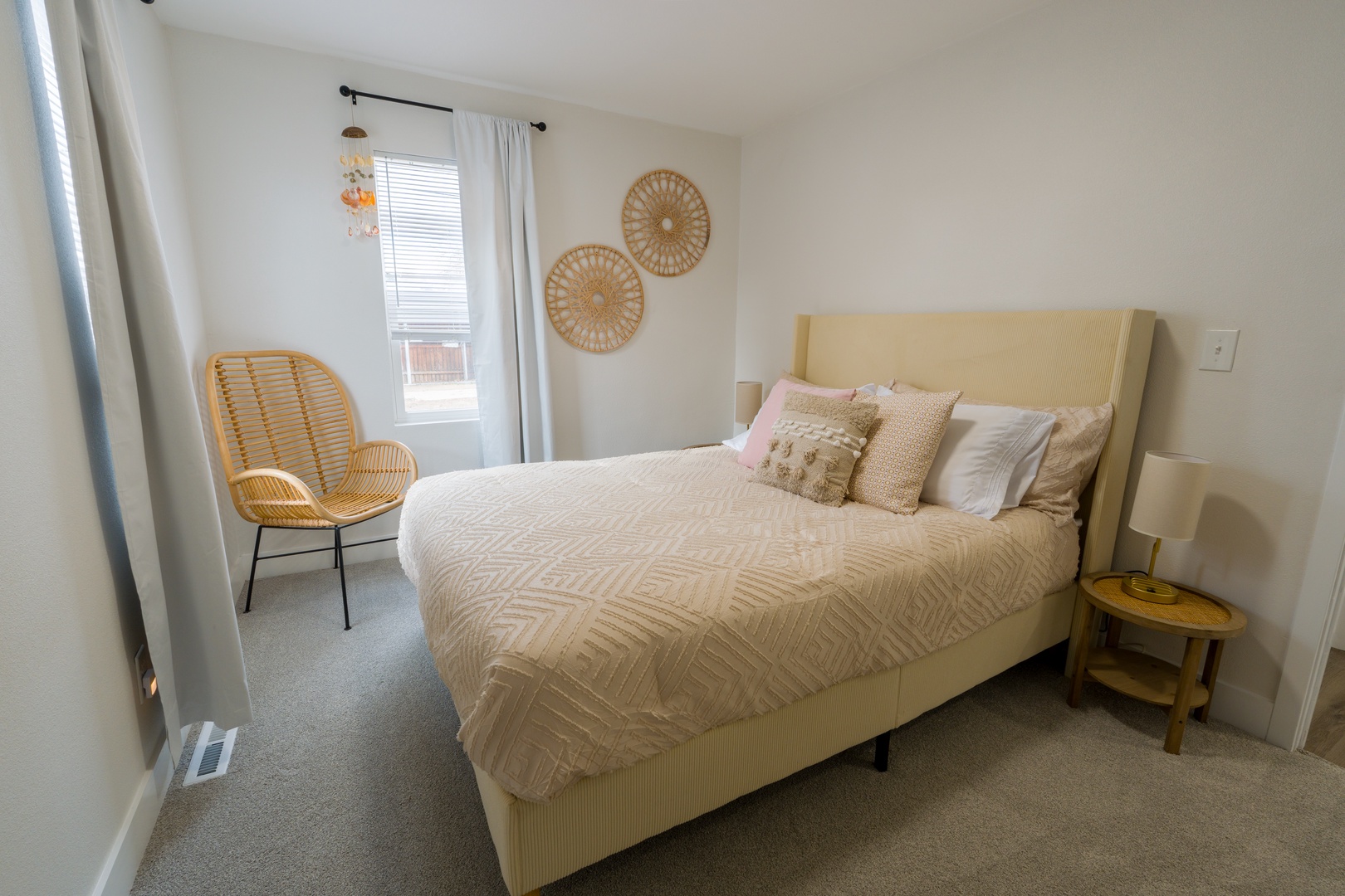 Drift off in your serene bedroom featuring a plush bed with soft linens, warm natural textures, and gentle light filtering through.