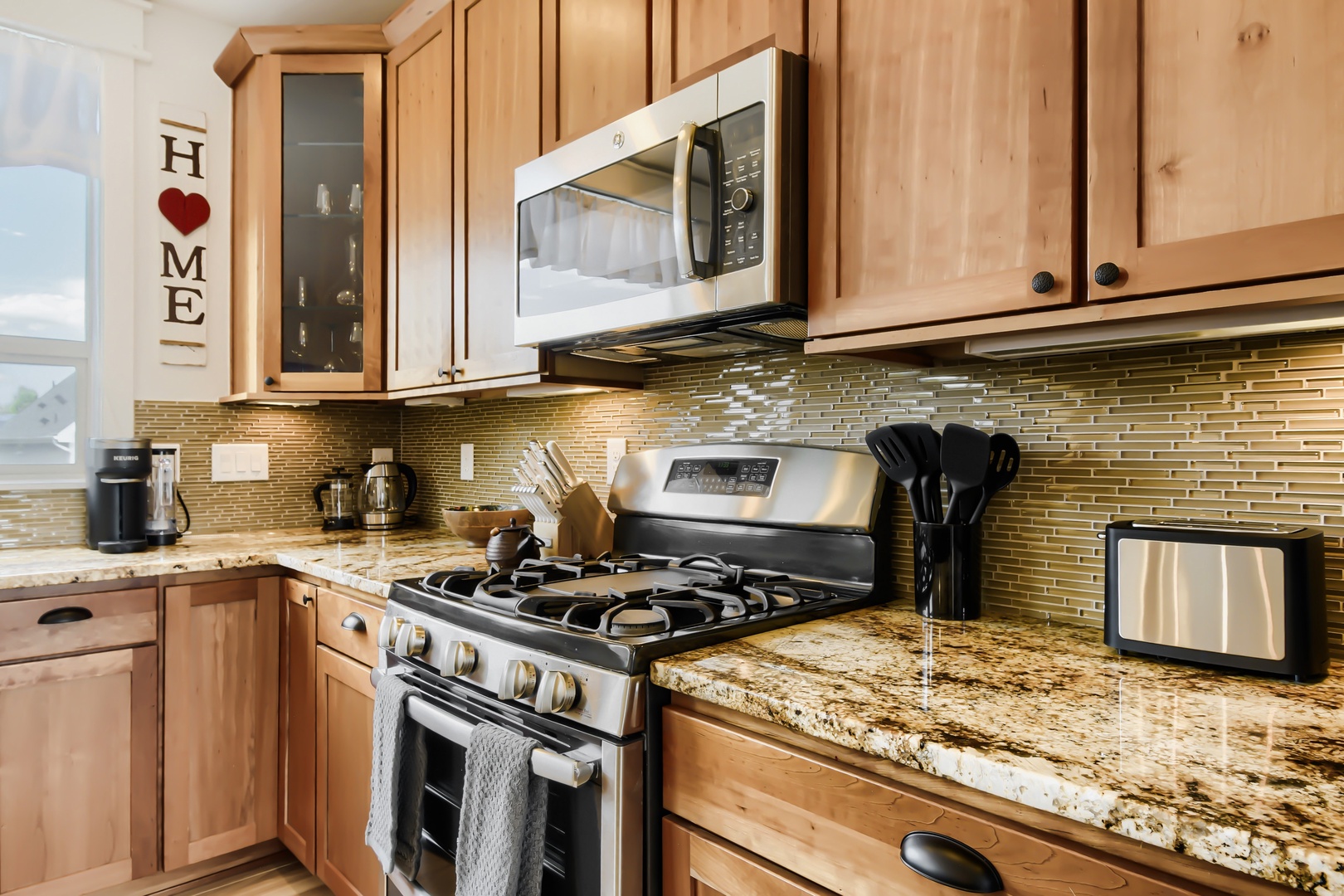 Your fully-equipped kitchen awaits with warm maple cabinetry, gleaming granite counters, and modern appliances—everything you need to prepare meals just the way you like.