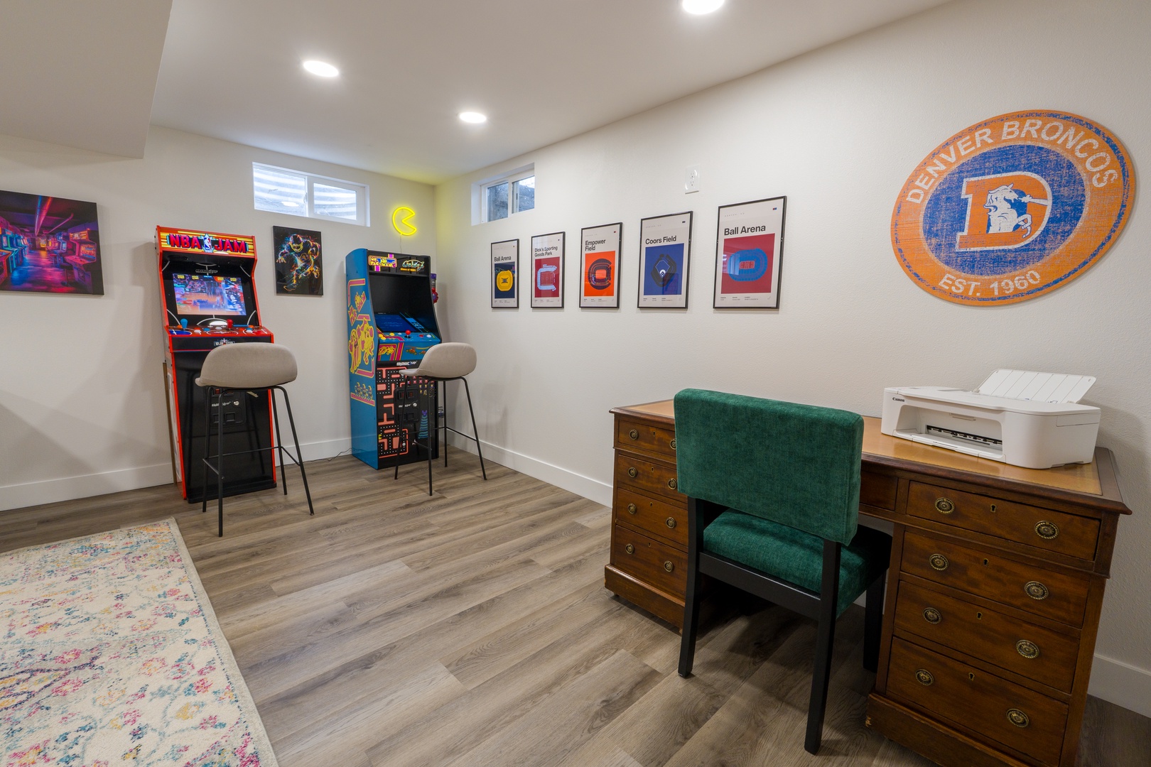 Your own arcade awaits with vintage games, comfortable seating, and a workspace for remote work or planning adventures.