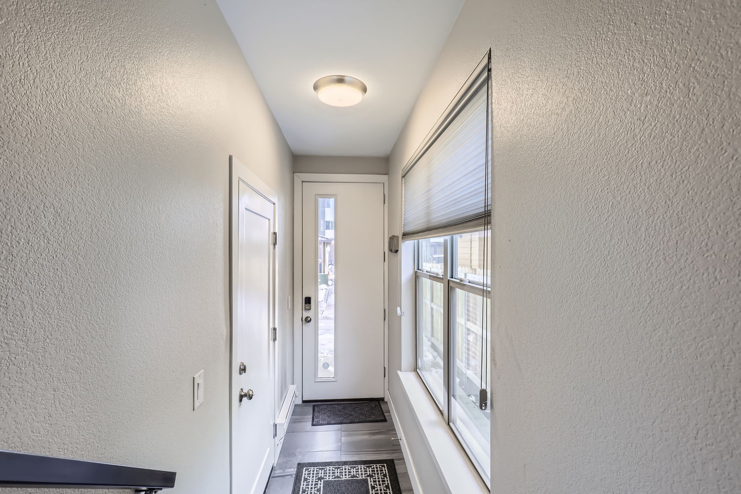 Bright, welcoming hallway with natural light streaming through large windows and a private entrance just for you.