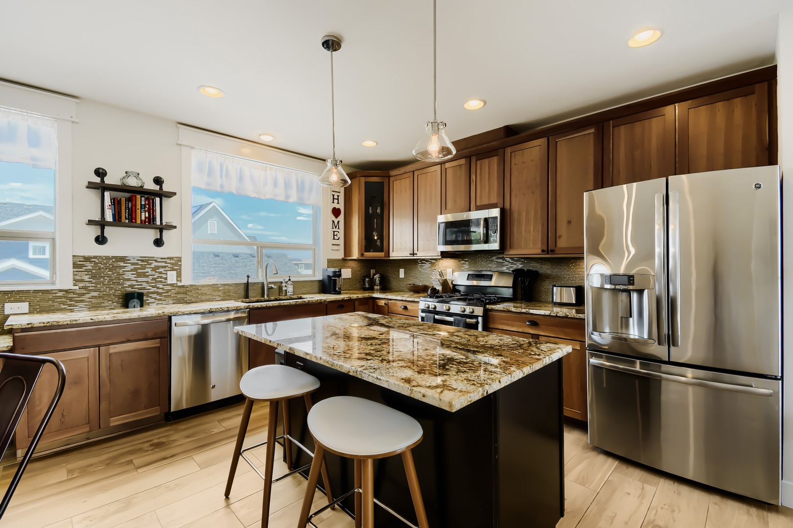 Picture yourself preparing meals in this bright, fully equipped kitchen with granite counters, modern appliances, and stunning water views through the windows—your home away from home awaits.