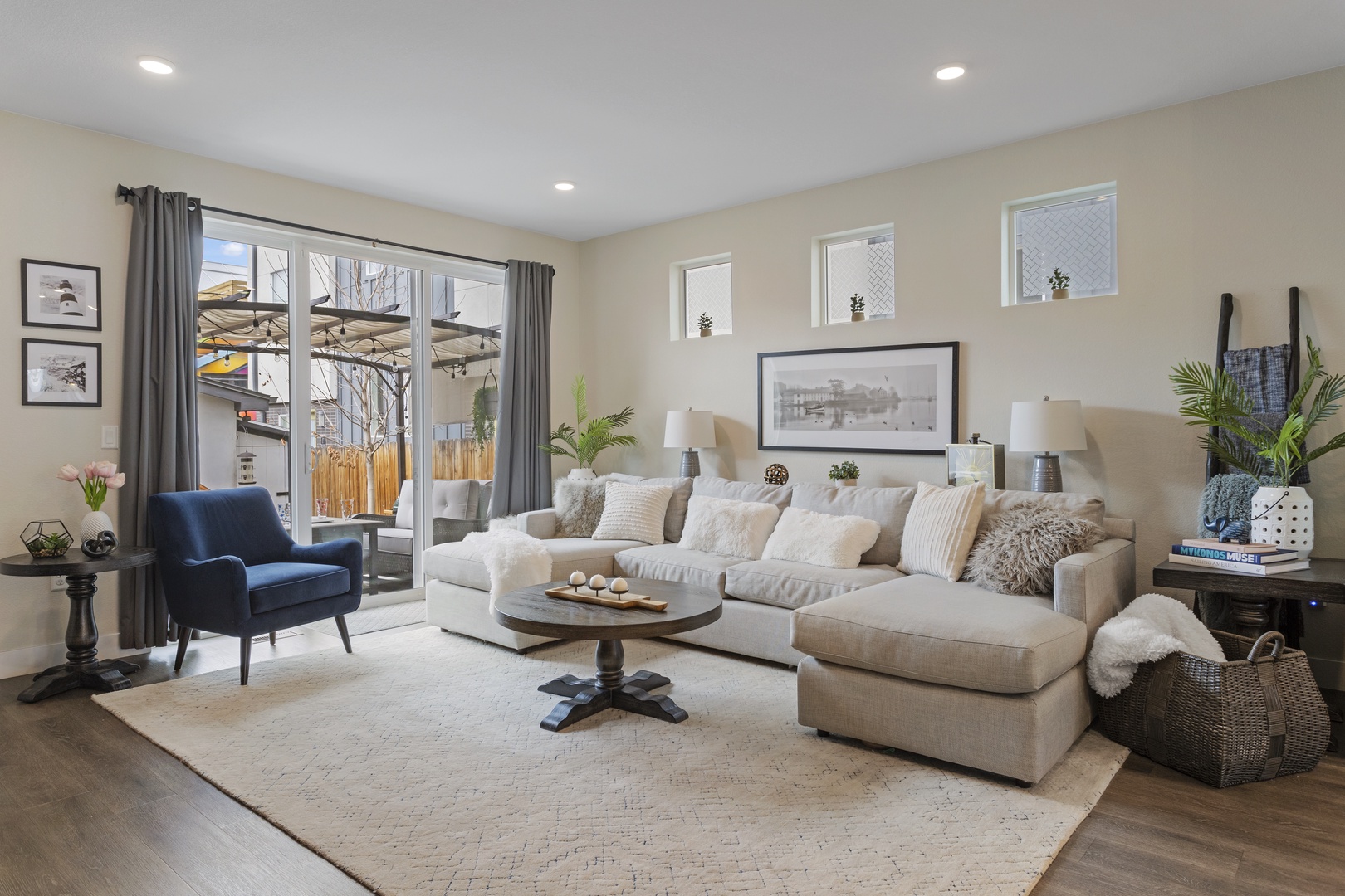 Sink into this plush sectional sofa where natural light flows through large windows, creating your perfect retreat for relaxation.