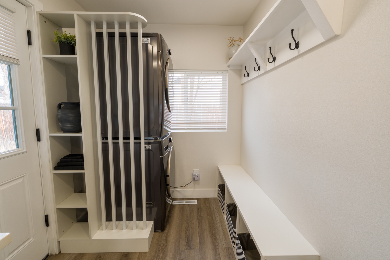 Your entryway offers thoughtful organization with built-in storage, hooks for jackets, and a convenient bench for settling in.