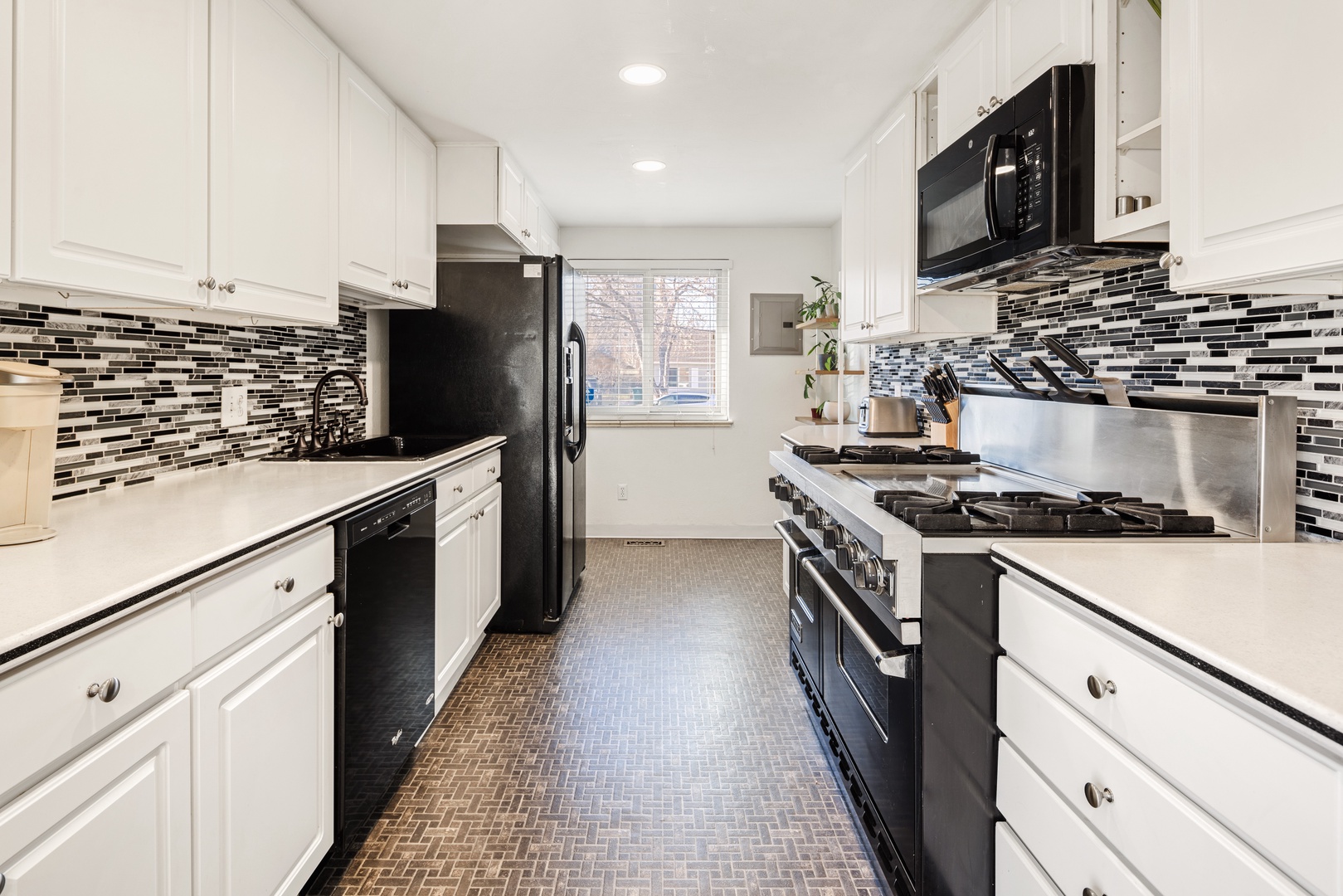 Your fully equipped galley kitchen features crisp white cabinets, sleek granite counters, and modern appliances ready for memorable meal prep.