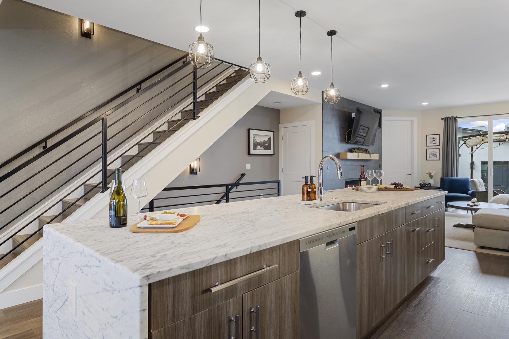Your modern kitchen island awaits with gleaming marble counters, pendant lighting, and open flow to the living area—perfect for entertaining.