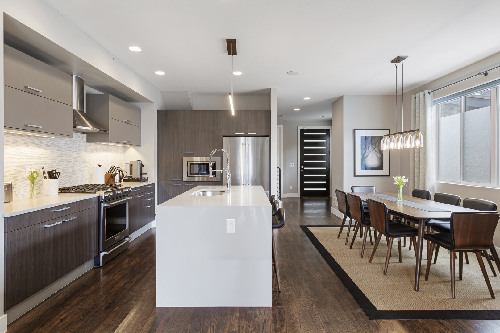 Your modern kitchen awaits with sleek appliances and spacious island for cooking adventures. Adjacent dining area creates perfect flow for memorable meals.