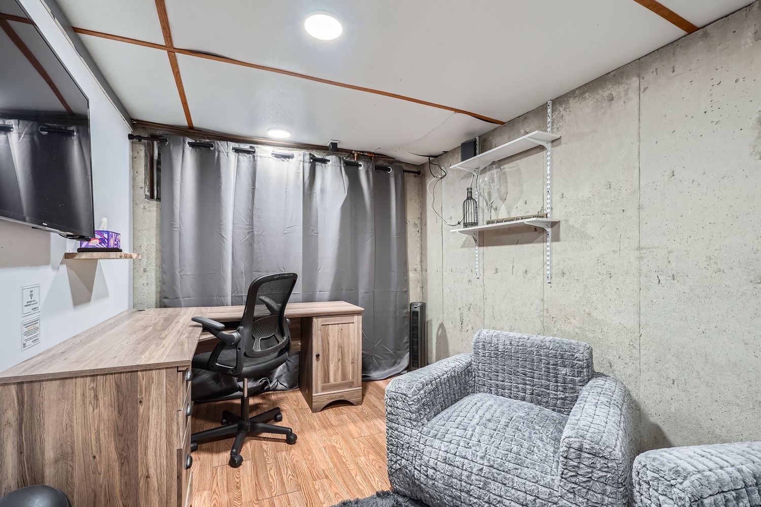 Your perfect work-from-home setup awaits, with a spacious desk, ergonomic chair, and cozy seating where you can unwind after a productive day.