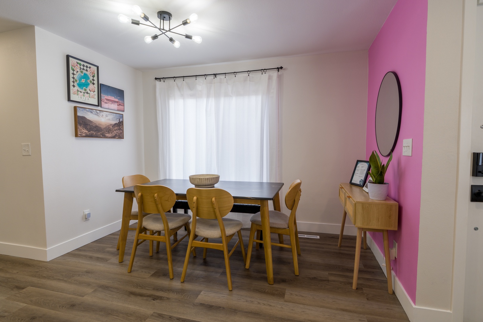 Gather around your stylish dining table where natural light streams through soft curtains, creating the perfect atmosphere for memorable meals together.
