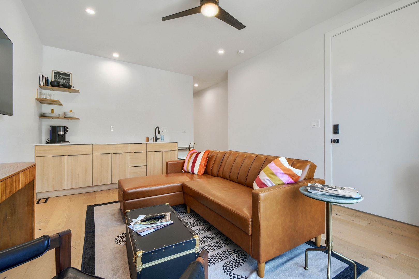 Your modern retreat blends style and comfort with sleek leather seating, a fully equipped kitchenette, and airy open design. Bright natural light and a ceiling fan create the perfect setting to relax and unwind.