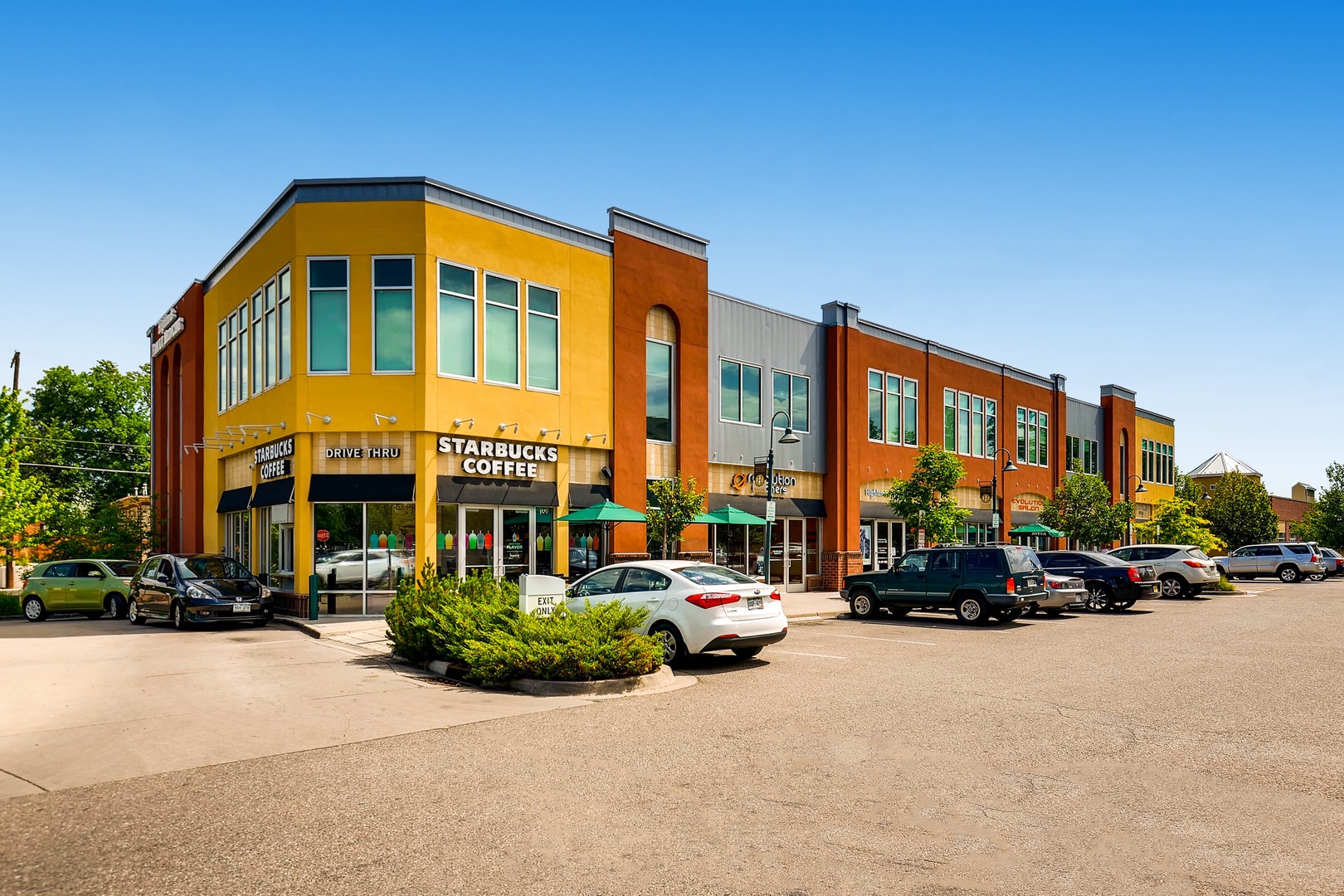 A vibrant commercial district featuring a Starbucks and nearby shops offers convenient access to coffee and local amenities during your stay.