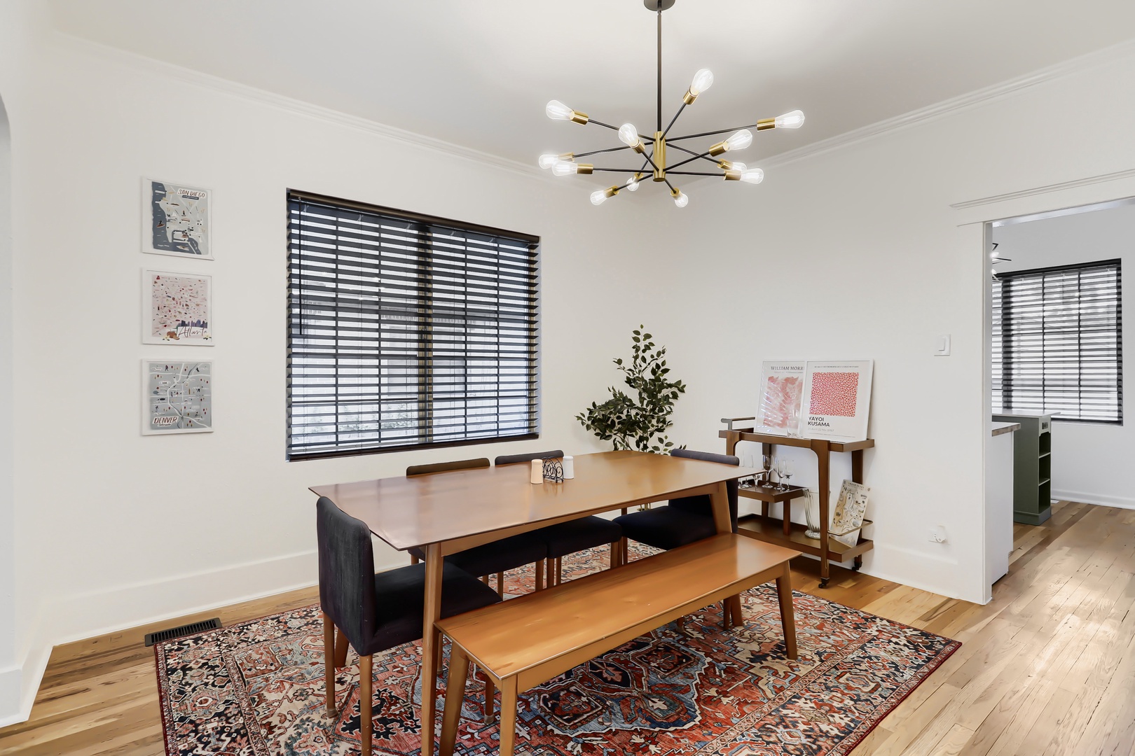 Gather around your stylish dining table beneath warm midcentury lighting, perfect for sharing meals and making memories with your travel companions.