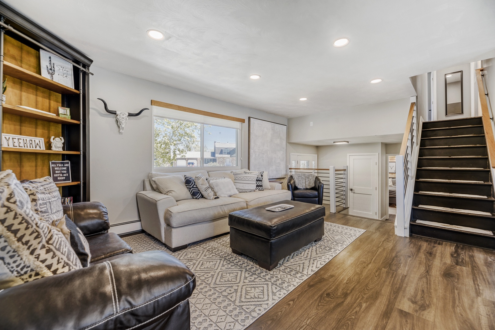 Settle into your stylish living space, where plush leather chairs and a cozy sofa invite you to unwind after exploring nearby attractions.