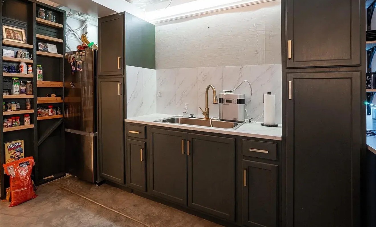 Your fully equipped kitchen features elegant dark cabinetry, marble countertops, and a well-stocked pantry for all your culinary adventures.