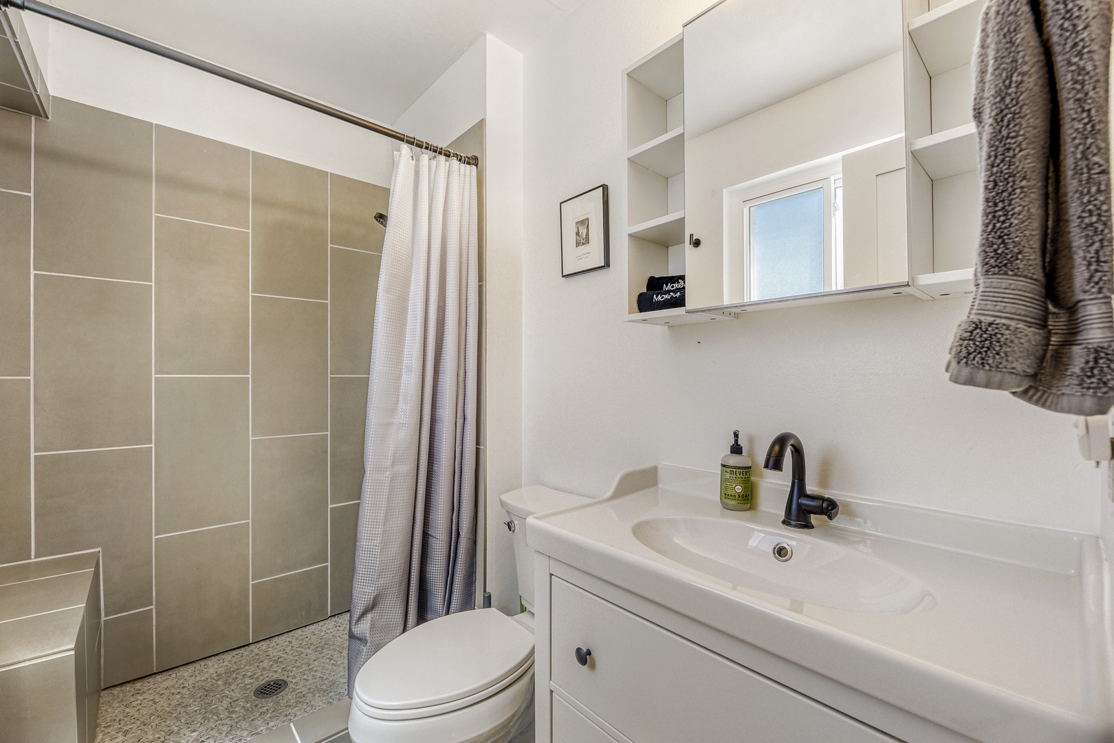 A bright, modern bathroom awaits you with crisp white vanity, sleek fixtures, and a spacious tiled shower—your own refreshing retreat to start and end each day.