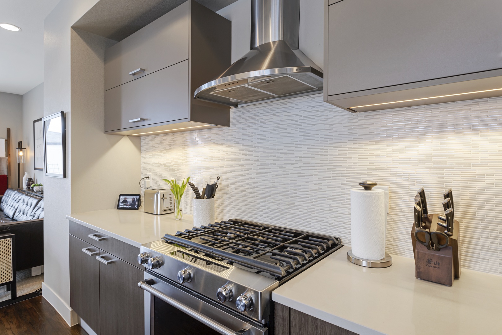 Cook your favorite meals in this modern kitchen featuring premium stainless appliances and sleek design.