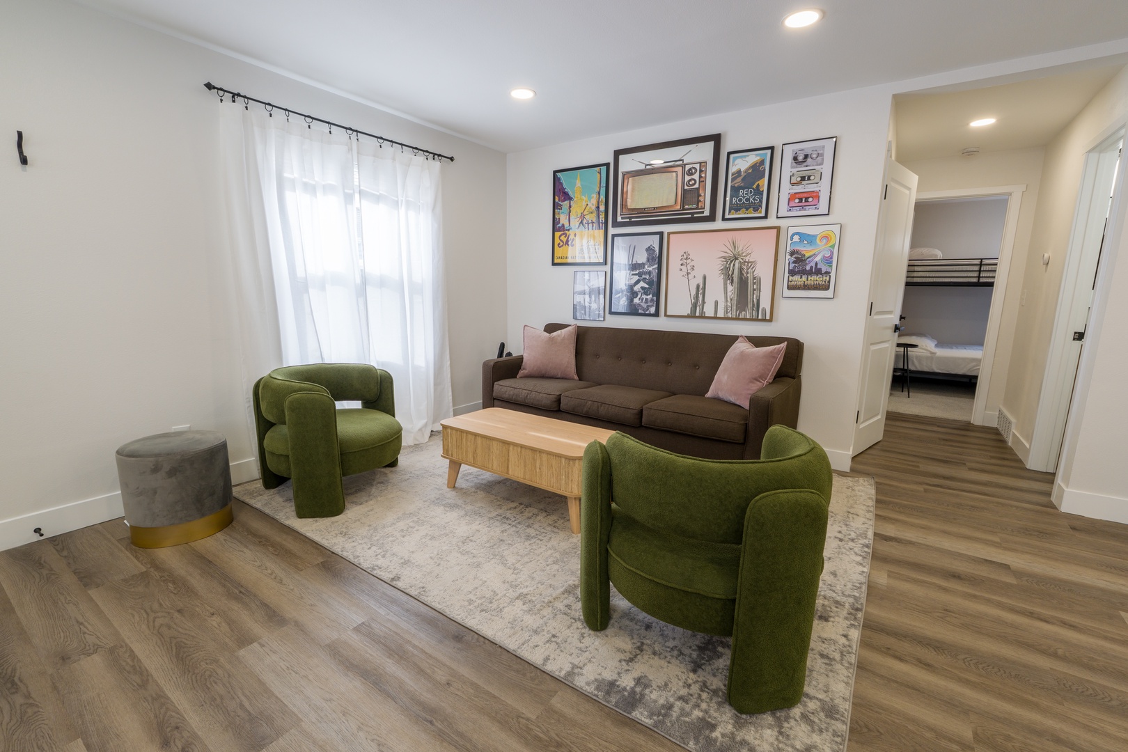 Sink into plush velvet chairs and unwind in your stylish living room, where curated art and warm lighting create the perfect retreat.