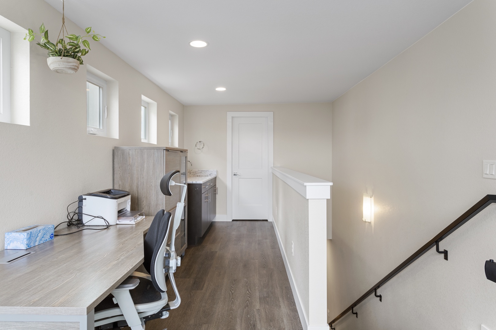 Your dedicated workspace awaits with natural light streaming through three windows, creating an inspiring environment for productivity during your stay.