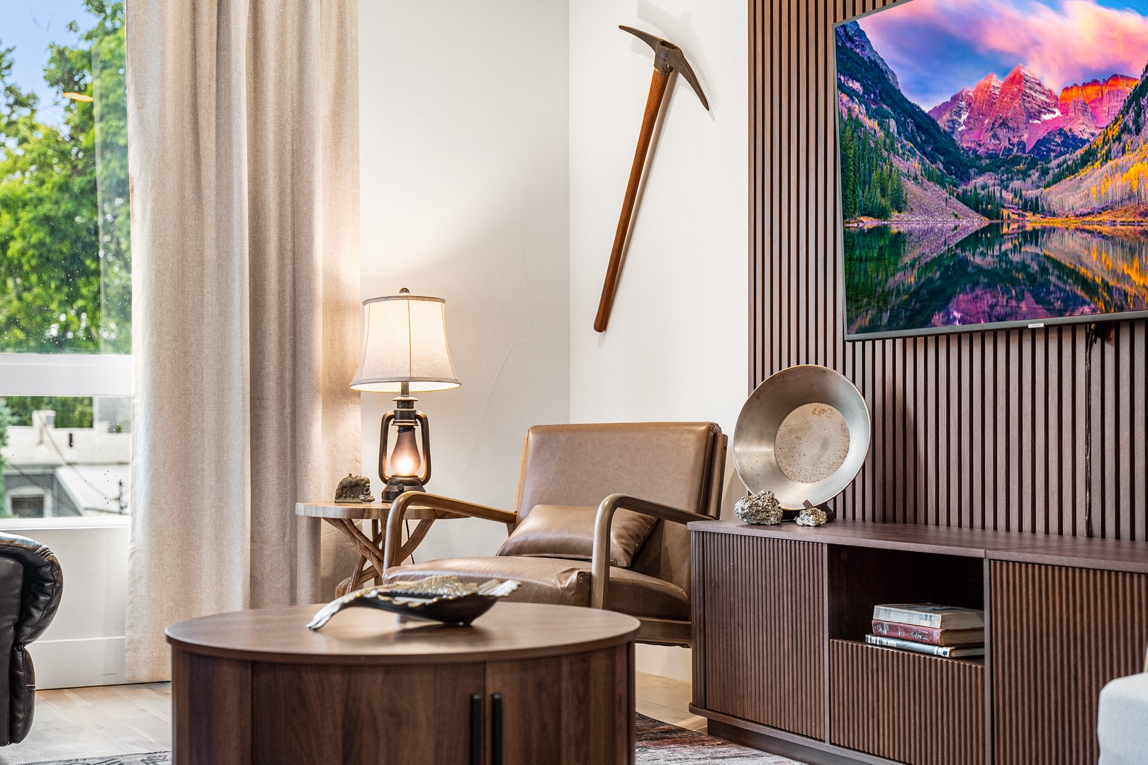 Sink into the leather armchair and unwind in your inviting living room, where rustic mountain décor and warm wood tones create a cozy retreat after a day exploring.