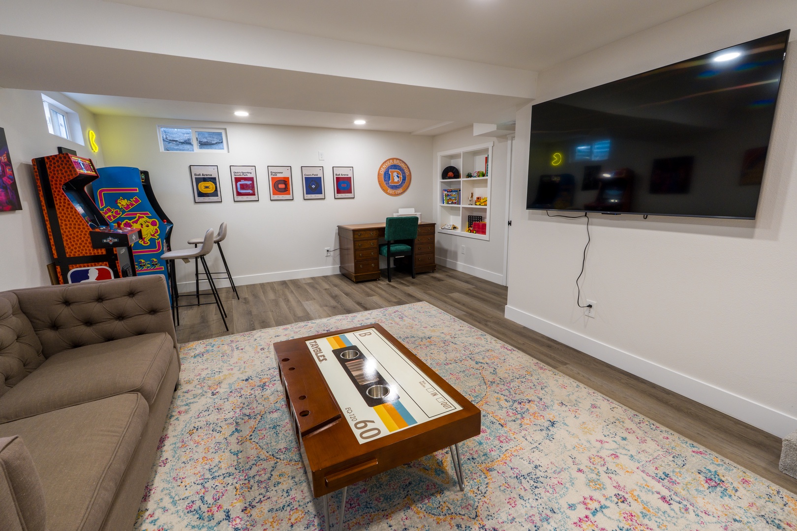 Unwind in your private game room with retro arcade fun, cozy seating, and a large screen for movie nights.