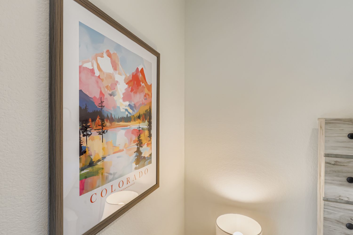 A clean, thoughtfully styled powder room features mountain-inspired artwork that brings Colorado's natural beauty into your home away from home. The serene atmosphere offers a quiet retreat throughout your stay.