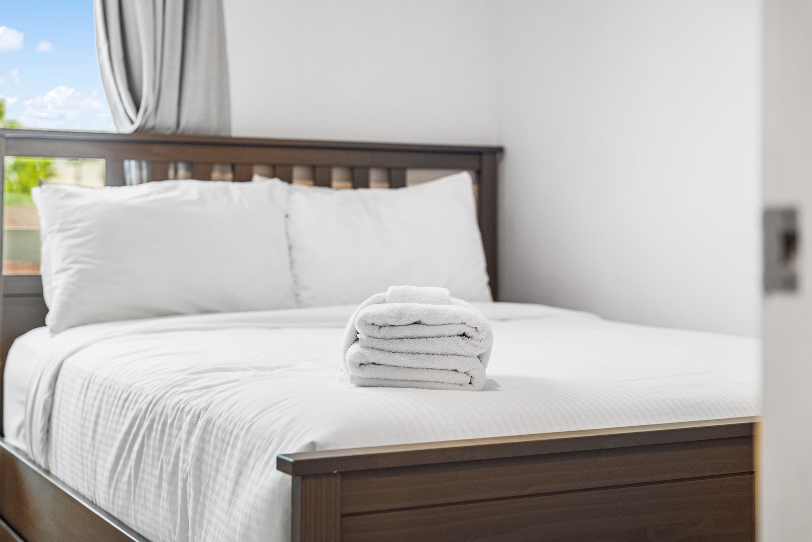 Sink into crisp, fresh linens and plush pillows in your private retreat, where soft towels await and natural light filters through to create your perfect escape.