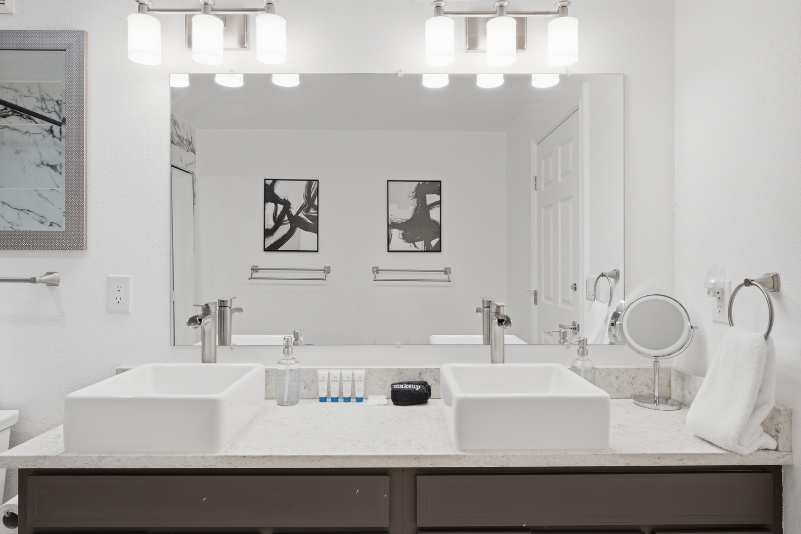 Step into your modern dual-vanity bathroom, where sleek vessel sinks and designer lighting create a spa-like atmosphere for your morning routine.