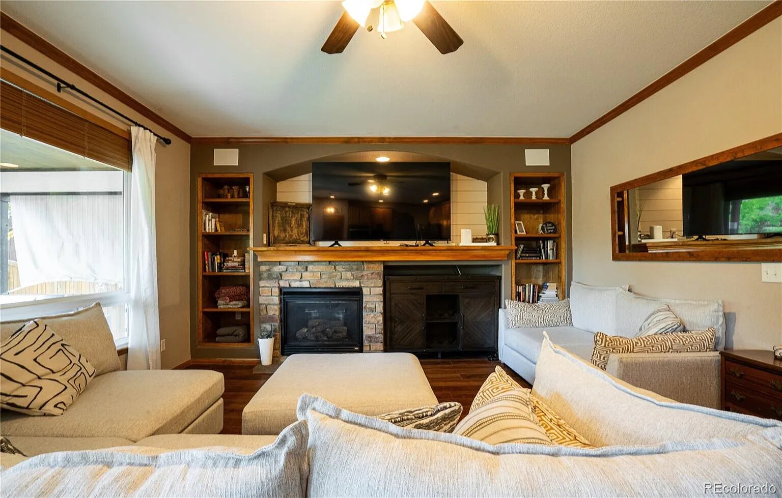 Sink into plush seating by the stone fireplace while your favorite shows play on the mounted TV in this cozy living room.