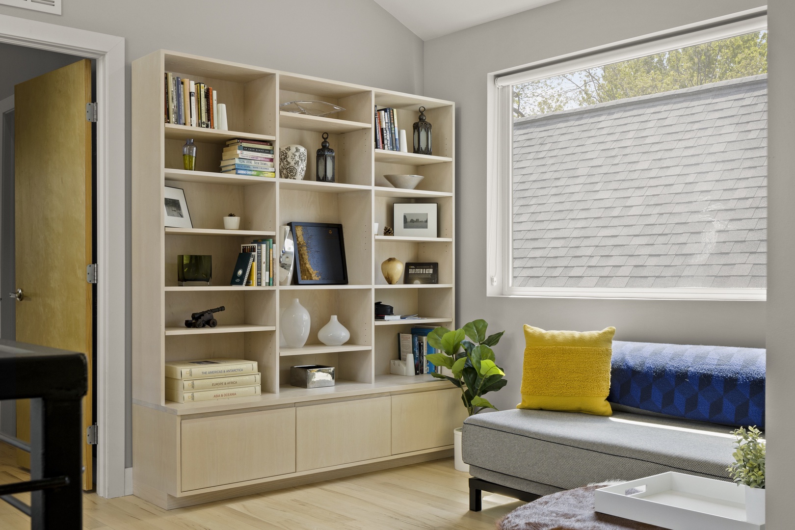 Sink into your reading nook with built-in shelves filled with books, perfect for quiet moments by the window.
