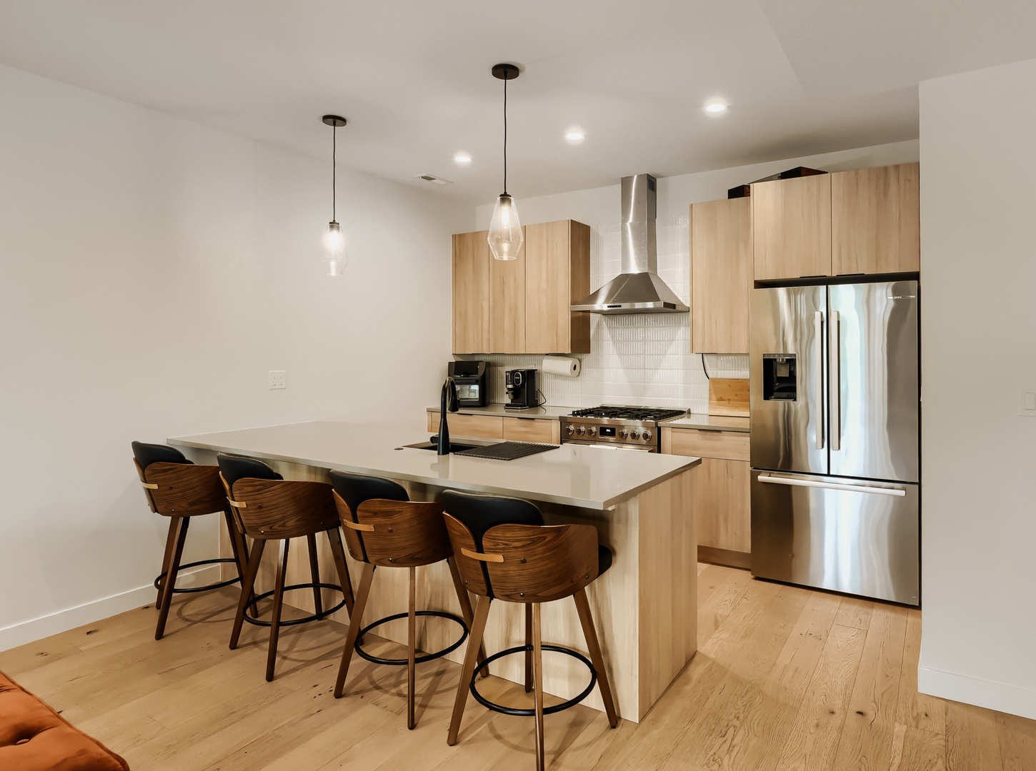 Your modern kitchen is perfectly equipped for everything from morning coffee to family meals, with sleek appliances and a spacious island where you can gather over breakfast or plan your day.