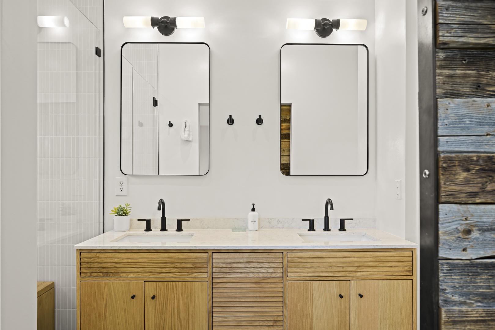 Refresh in your spacious double vanity bathroom, featuring modern fixtures and warm wood cabinetry for a spa-like morning routine.