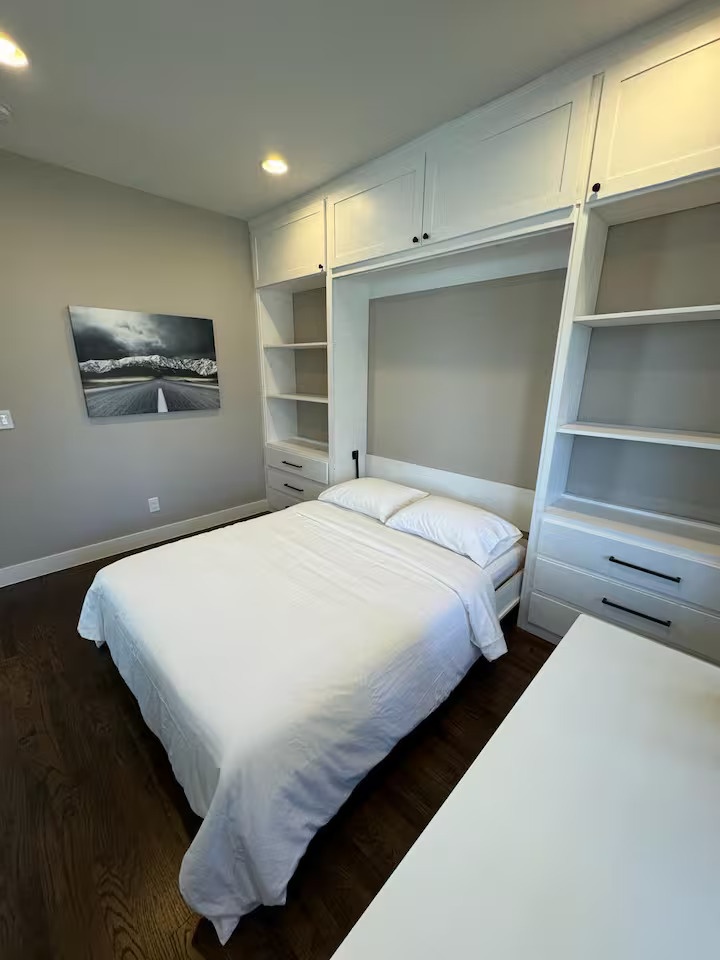 Your comfortable Murphy bed tucks seamlessly into custom built-ins, maximizing space with smart storage solutions for your stay.