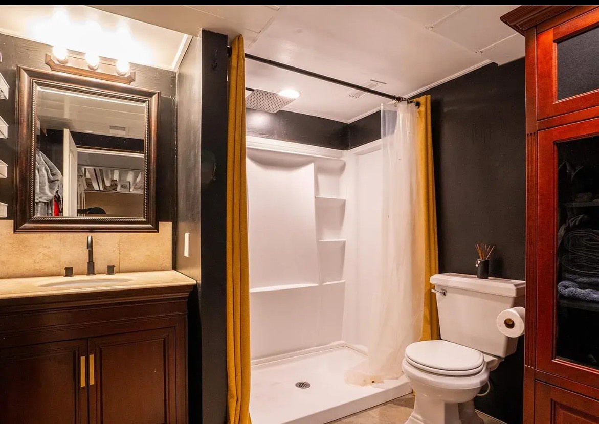 Refresh in your stylish bathroom featuring a spacious walk-in shower, elegant vanity, and thoughtful storage—all designed for your comfort.