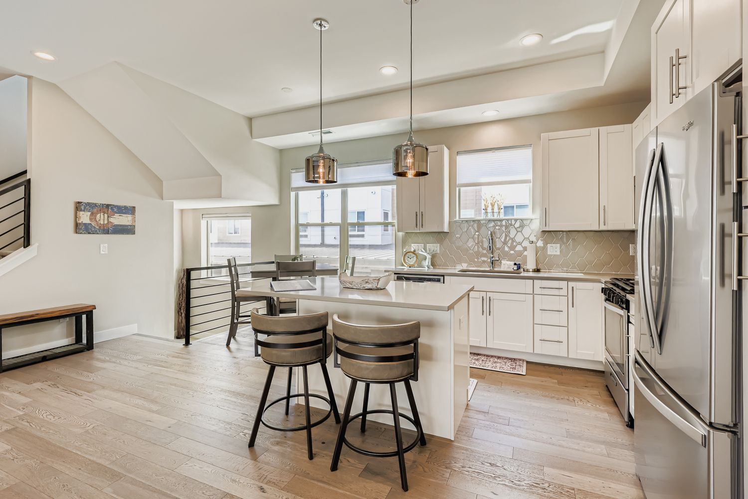 Step into your bright, airy kitchen where gleaming countertops and modern appliances await your culinary creations. Gather at the island for morning coffee or meals with a view through sunny windows.