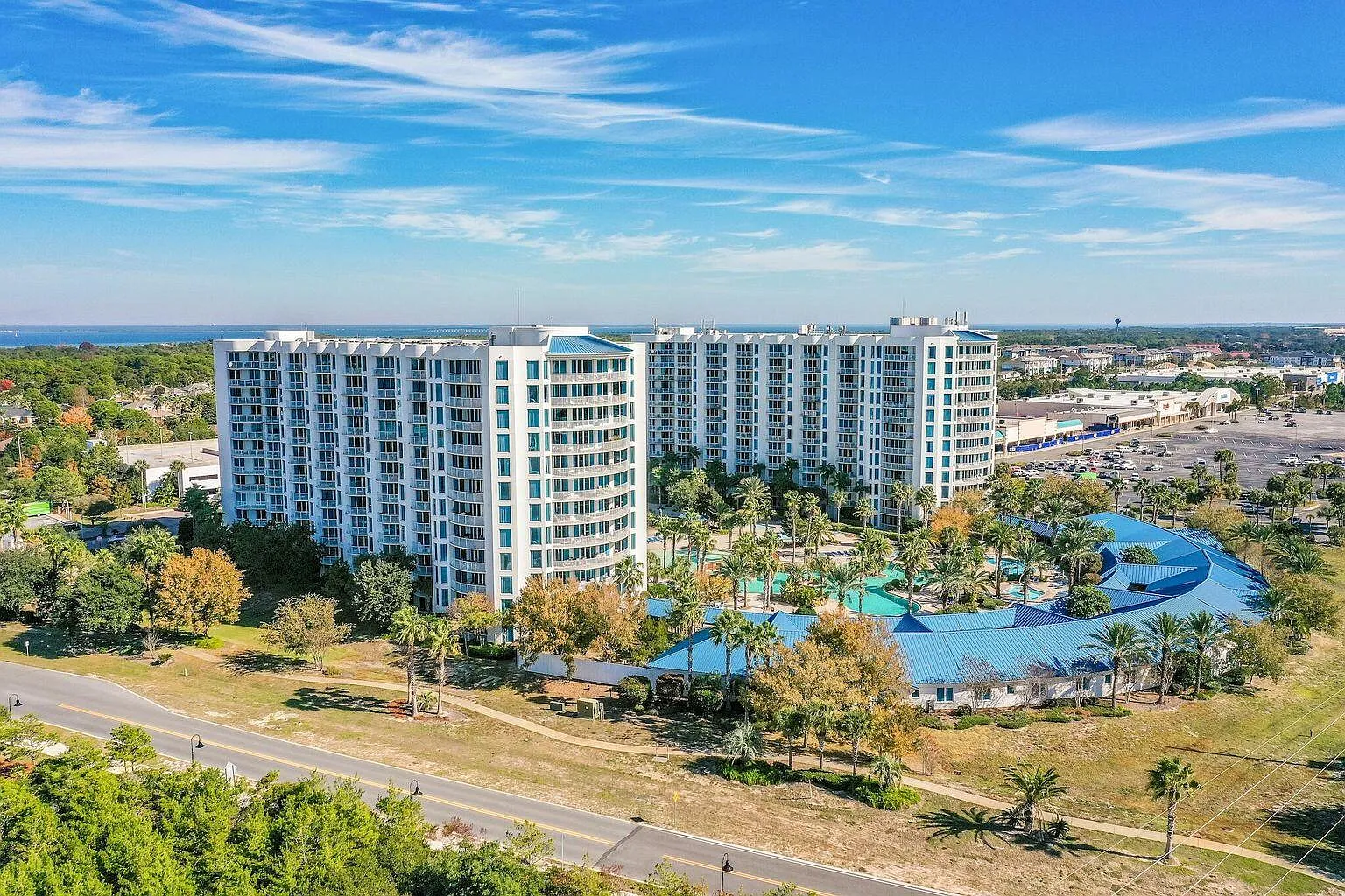 Modern resort complex with distinctive curved architecture, featuring multiple high-rise towers and extensive recreational facilities surrounded by tropical landscaping.