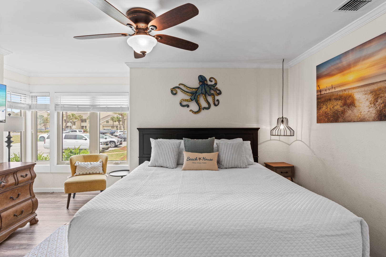 Drift off in your serene bedroom, where coastal charm meets comfort with thoughtful decor and gentle ceiling fan breezes.