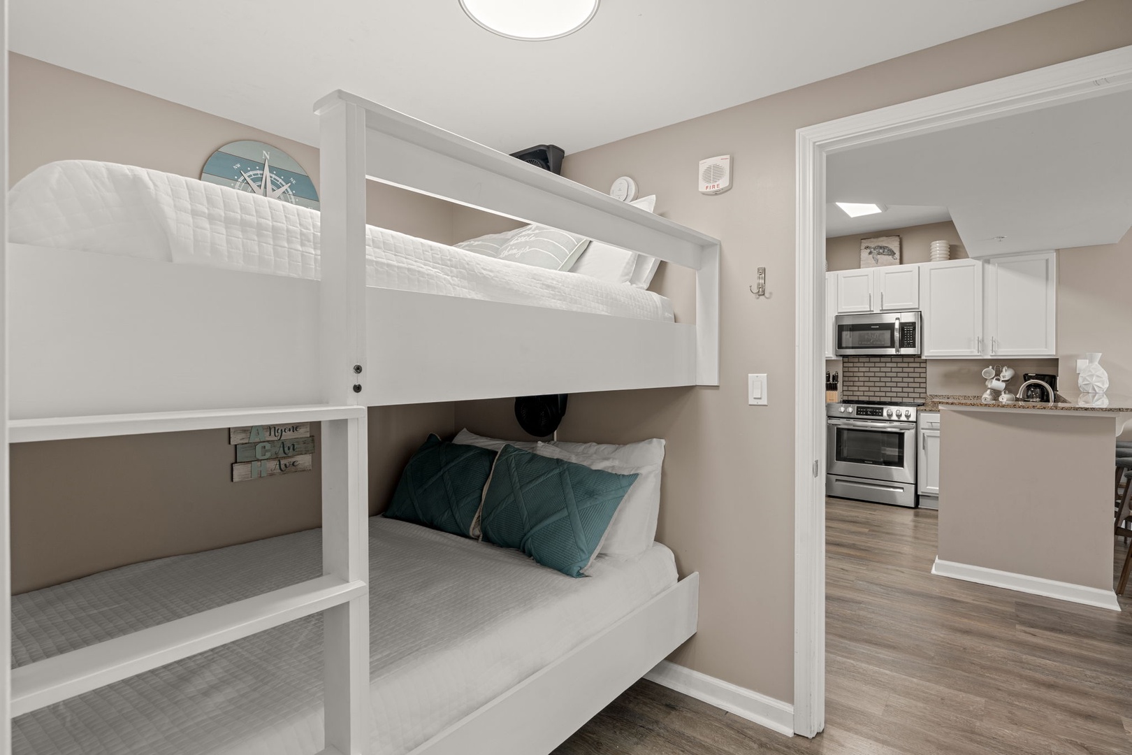 Your family-friendly bunk room connects seamlessly to the full kitchen, keeping everyone close while offering restful retreat after busy beach days. Crisp linens and coastal accents make bedtime feel special.