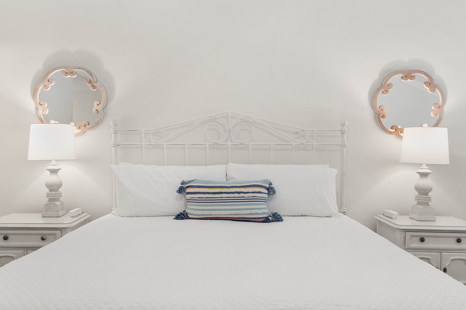 Drift off peacefully in your serene bedroom, with crisp white linens and charming nautical accents creating the perfect coastal retreat.