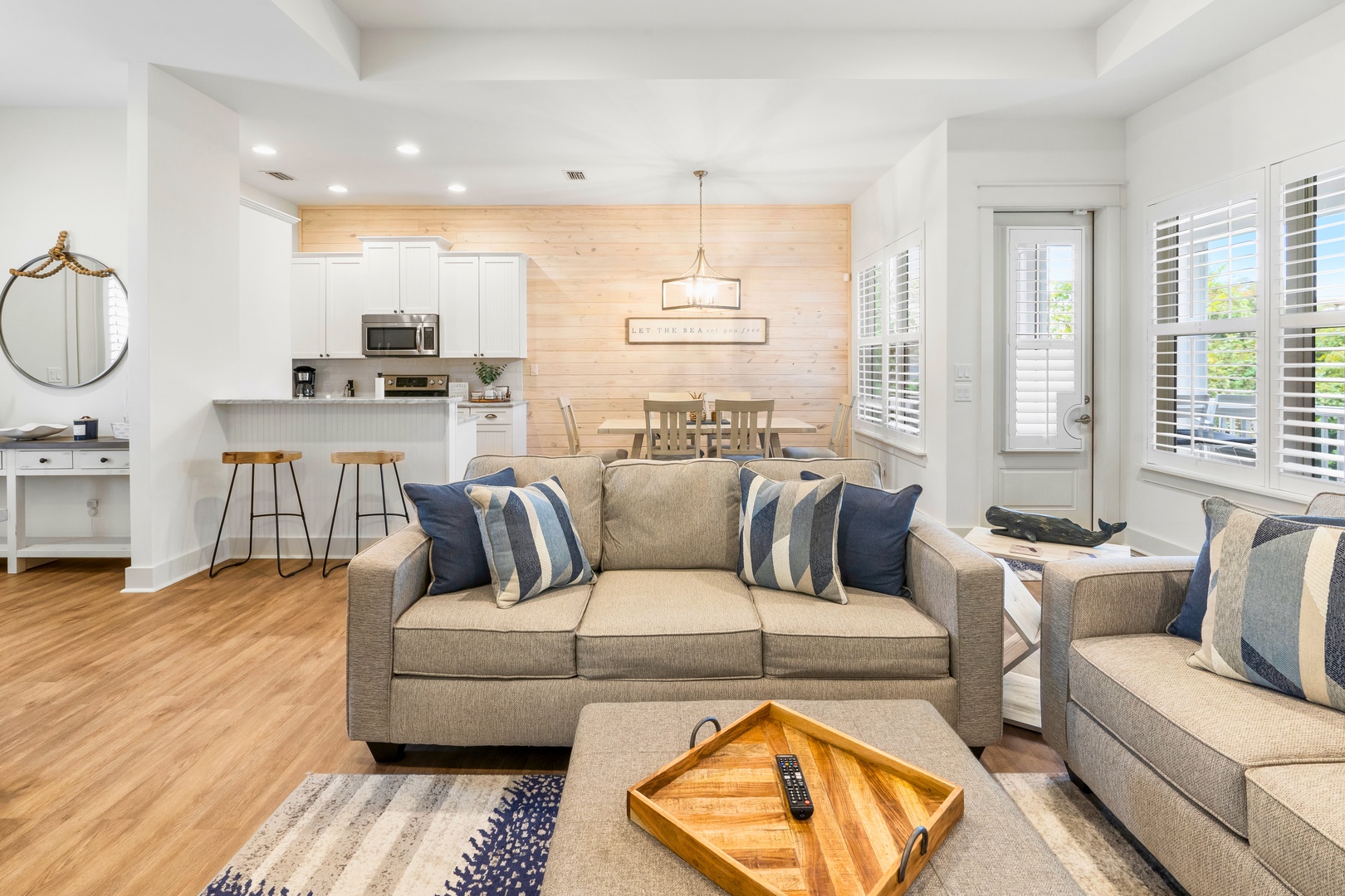Relax in your bright, modern living space with plush seating and an open kitchen perfect for preparing meals together.