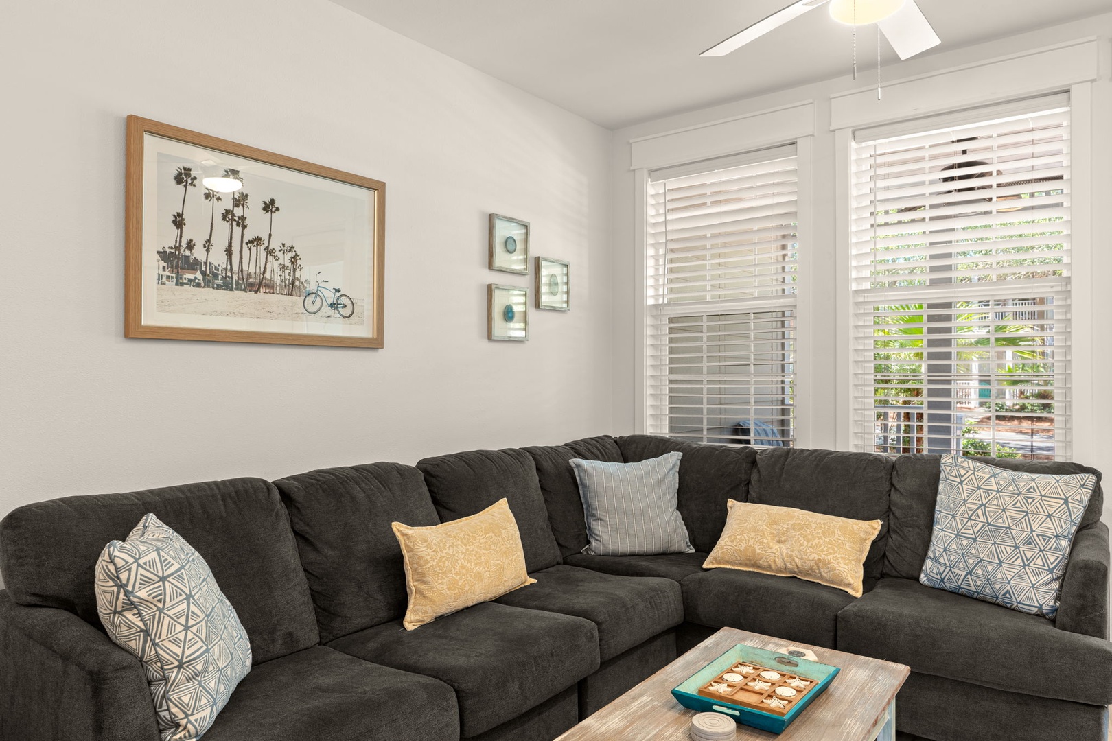Sink into the plush sectional and unwind in your bright, airy living room—perfect for cozy movie nights or catching up after a day exploring the coast.