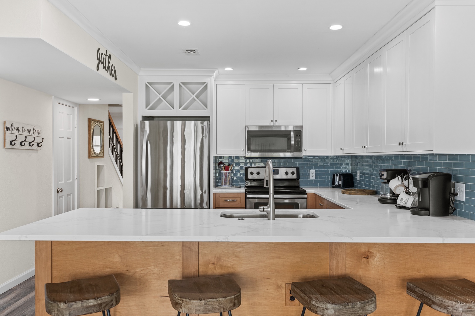 Your gourmet kitchen awaits with stainless steel appliances, granite counters, and a breakfast bar where morning coffee tastes even better.