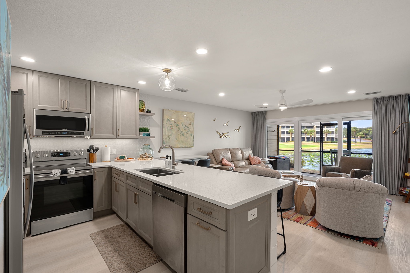 Your spacious kitchen island flows seamlessly into the cozy living area, where you can cook, dine, and relax while enjoying views of the water.