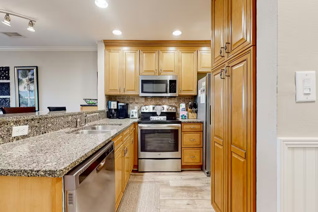 Your fully equipped kitchen features granite countertops, stainless steel appliances, and custom cabinetry—everything you need to prepare meals and gather with loved ones during your stay.