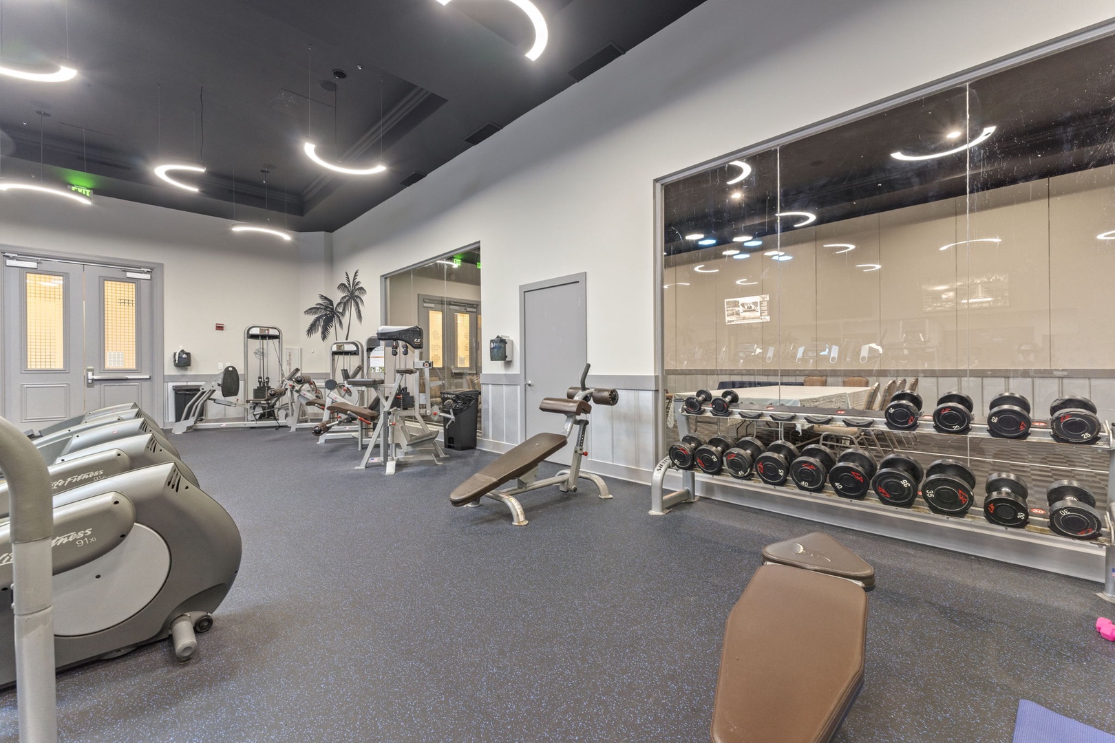 Step into a fully-equipped fitness center with modern machines, free weights, and stylish lighting—your perfect space to energize your mornings or unwind after exploring.