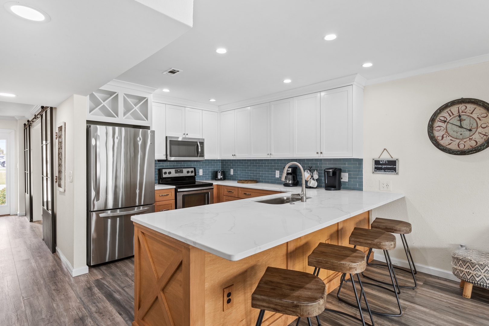 Your fully equipped kitchen features modern appliances, stylish island seating, and everything needed for memorable meals together.