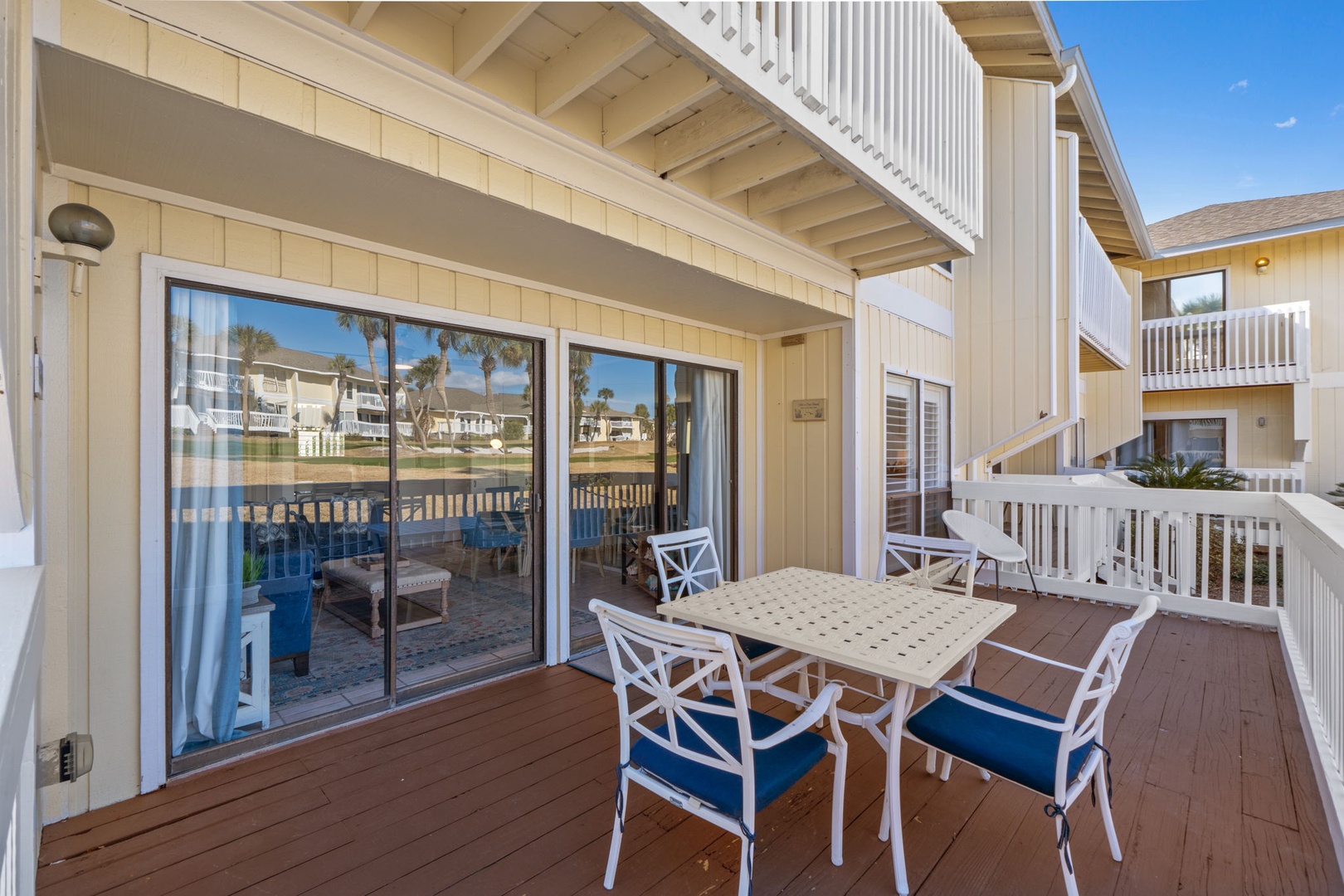 Your private balcony offers the perfect spot for morning coffee or sunset dining, with comfortable seating and serene waterfront views just beyond the railing.