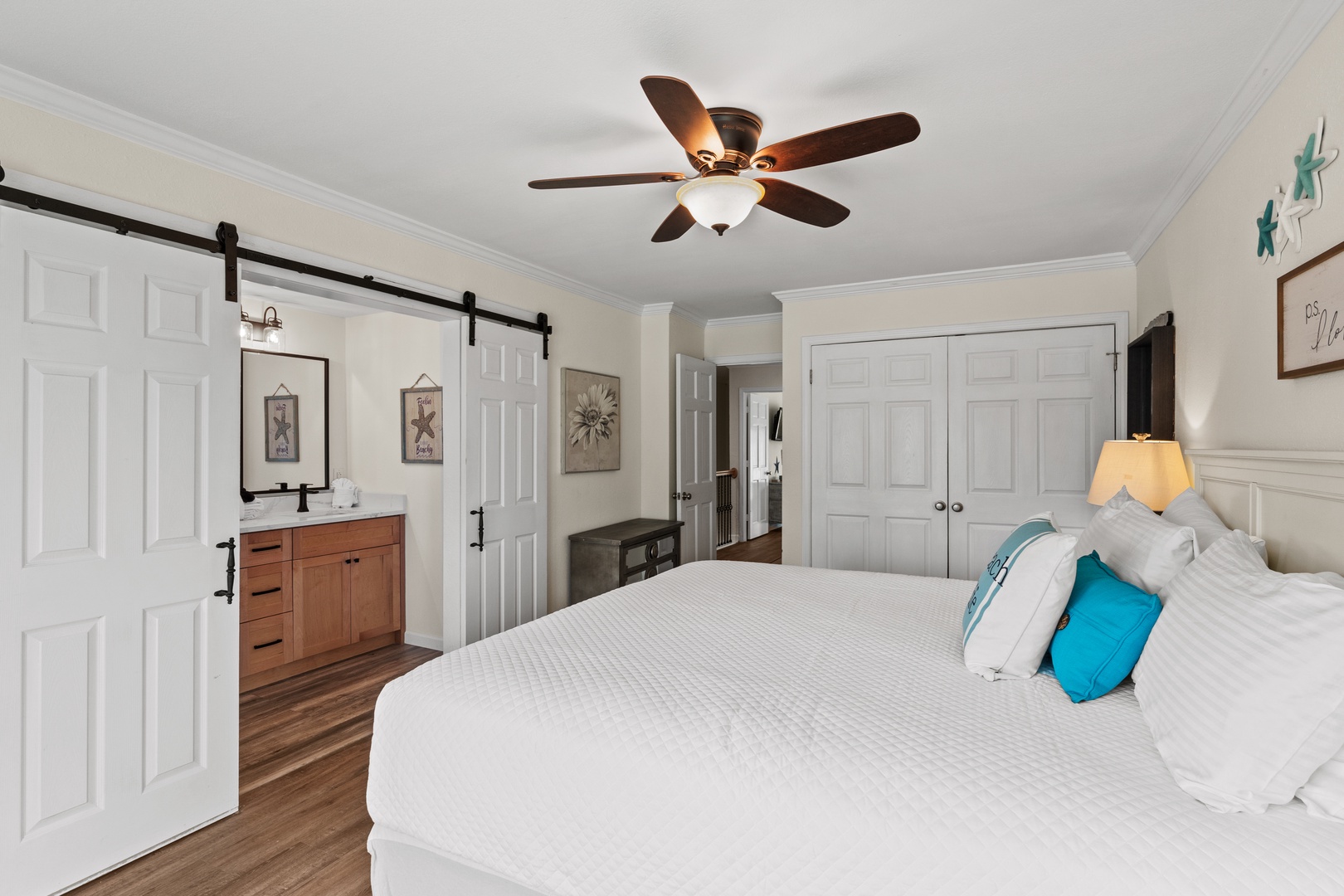 Drift into peaceful dreams in your coastal-inspired bedroom, complete with barn door charm and soothing ocean hues.