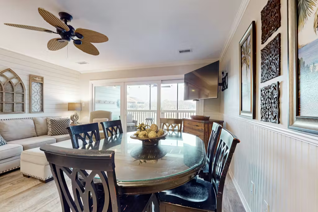 Gather around the elegant dining table for meals together, then relax in your inviting living space with coastal-inspired décor and easy access to your private balcony.