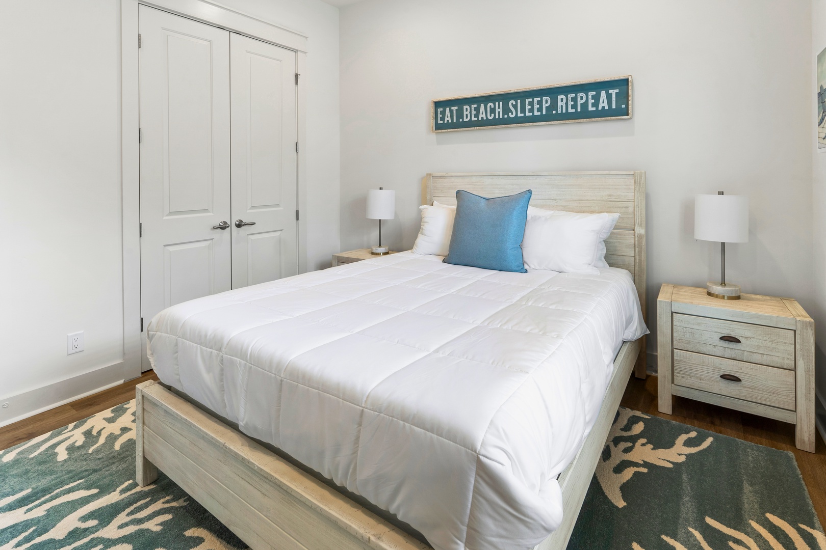 Sink into crisp white linens and coastal vibes in your serene bedroom retreat, where beach-inspired decor and soft lighting create the perfect escape.